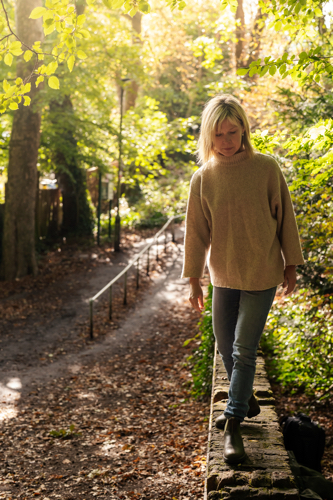 Portrait of Bethany Macdonald walking by an autumnal path