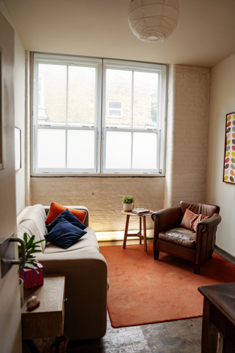 A therapist's consulting room, with a sofa and an armchair